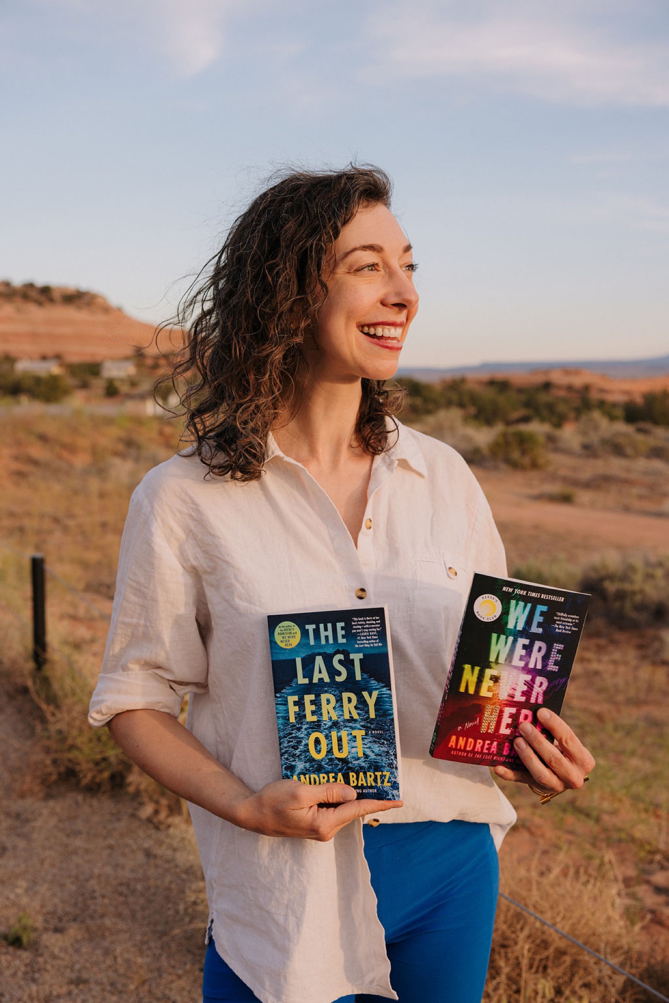 Author Andrea Bartz holding two books at Camp Unwritten in Moab