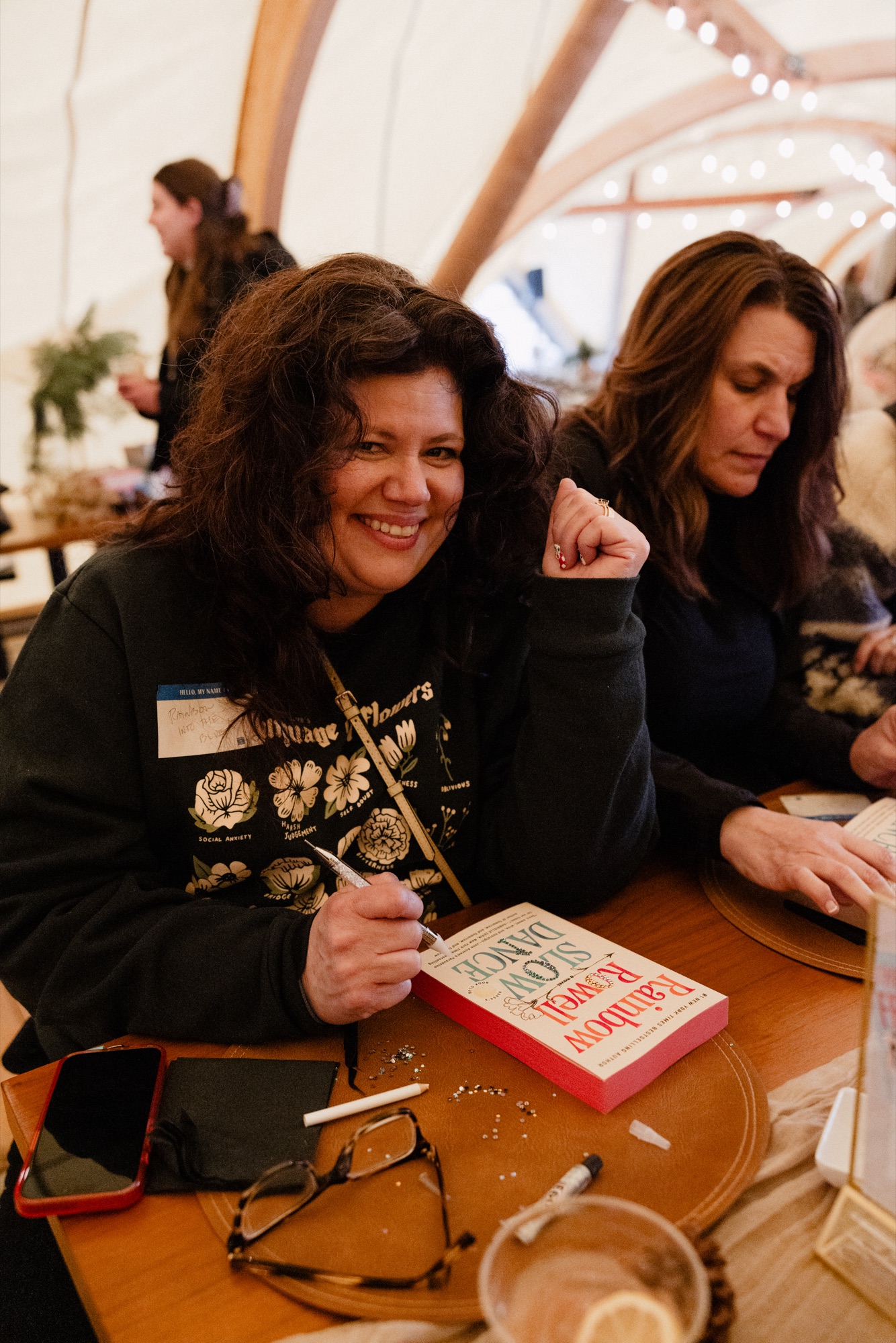 A Camp Unwritten guest personalizing a featured book