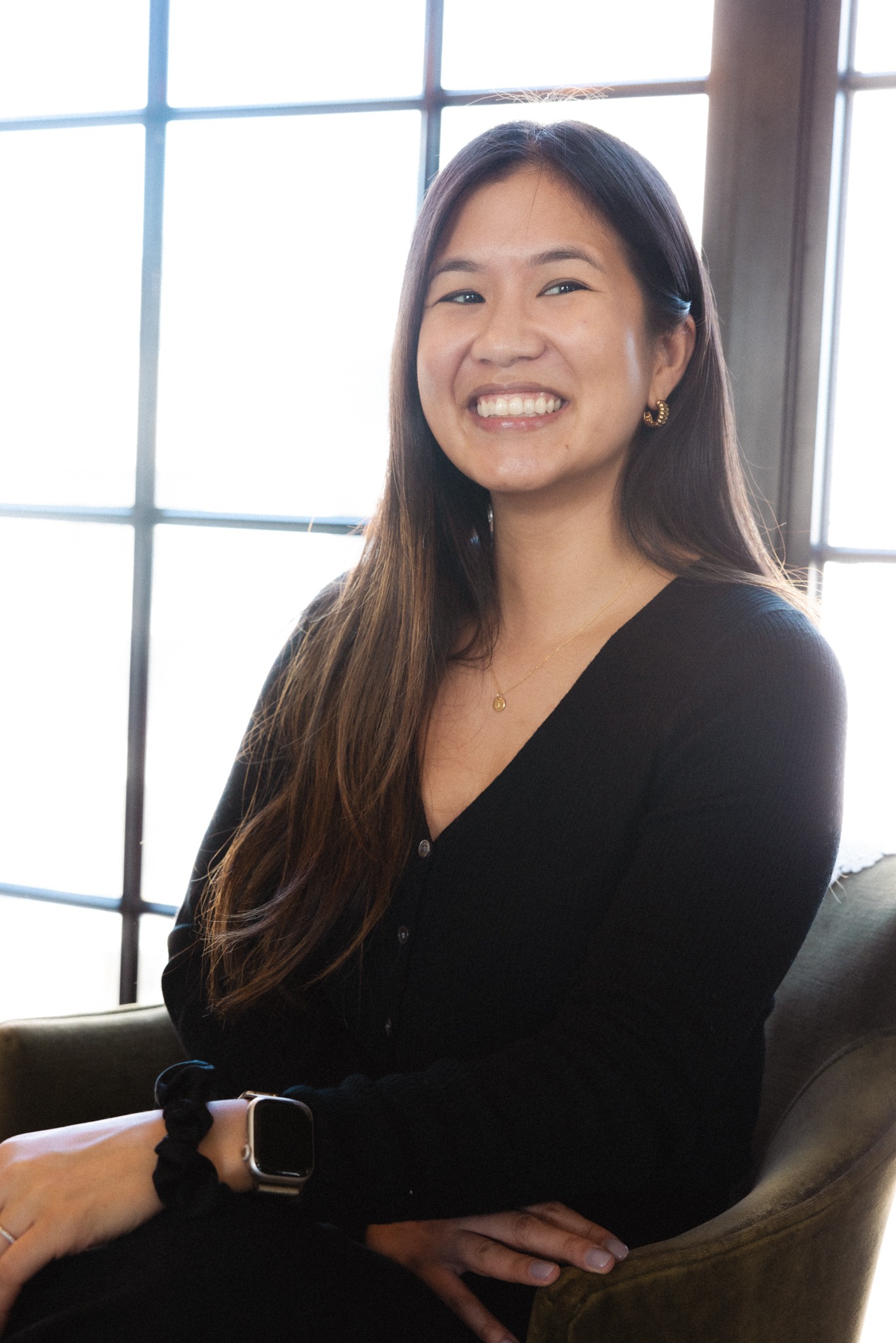 Jane K Lee smiling in a chair