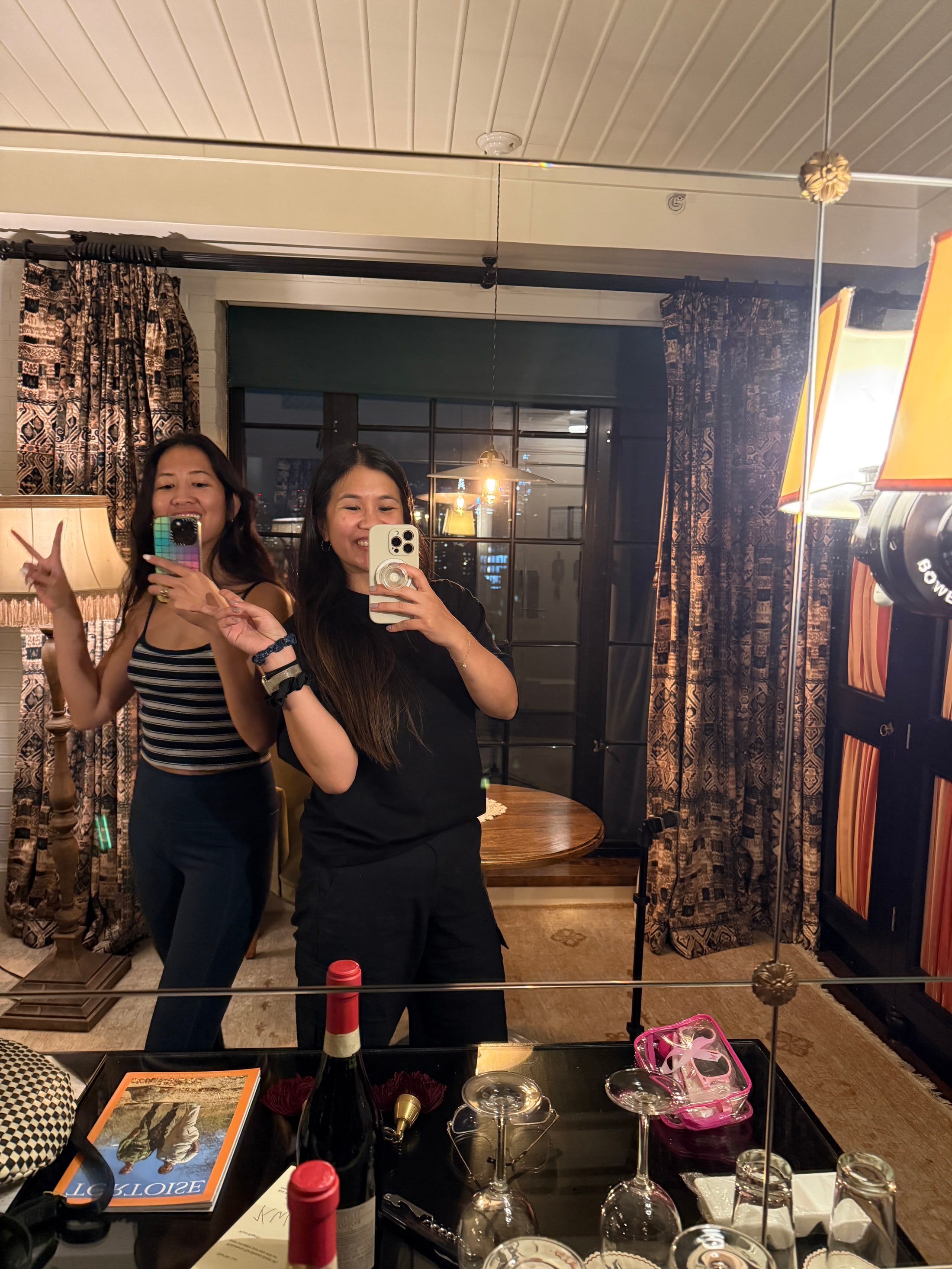 Jane K Lee and her creative partner taking a mirror photo while scouting The Bowery Hotel the night before Riley Keough’s shoot.