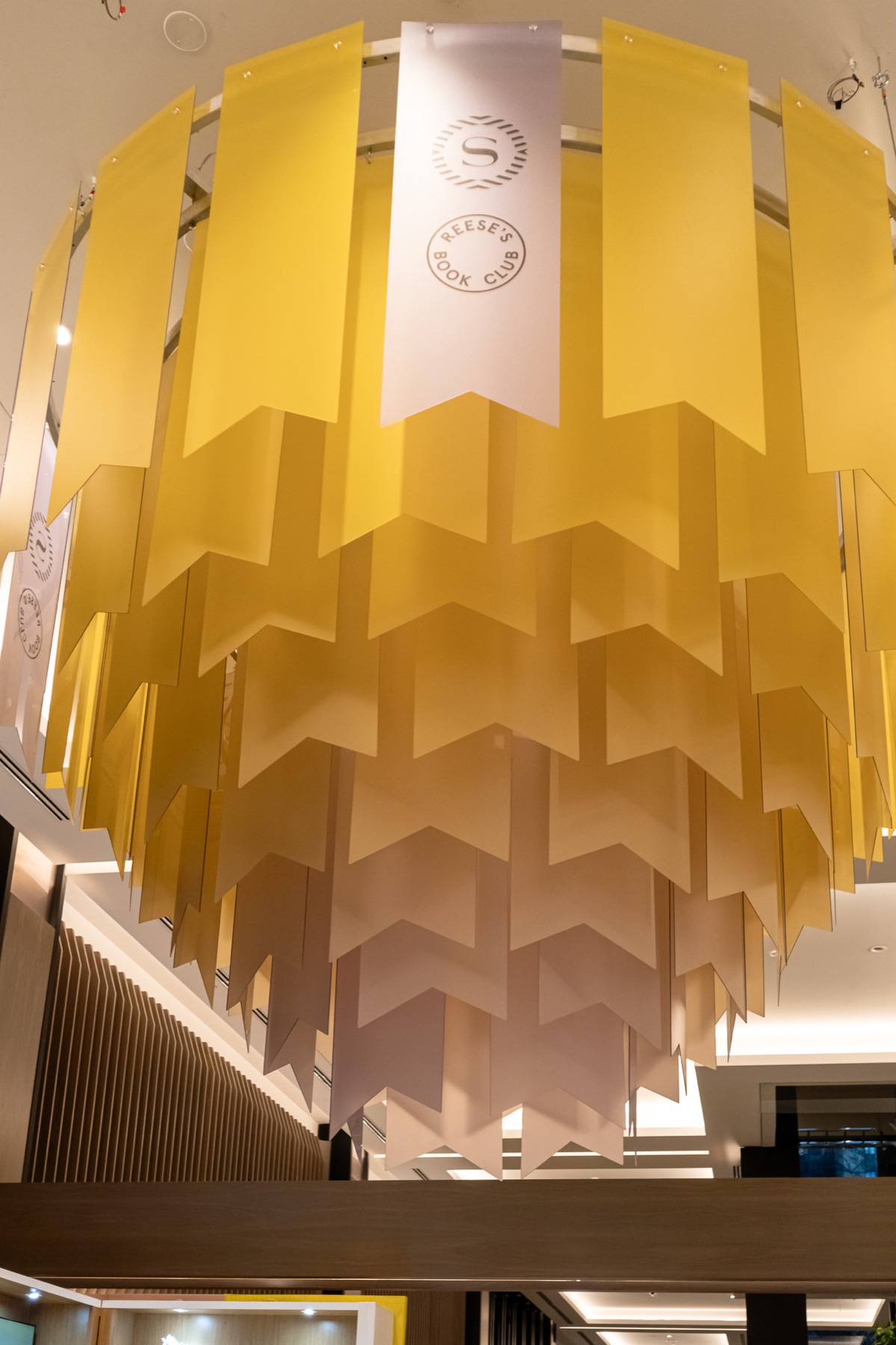 Bookmark chandelier hanging above the Reese’s Book Club Lobby Library in Toronto