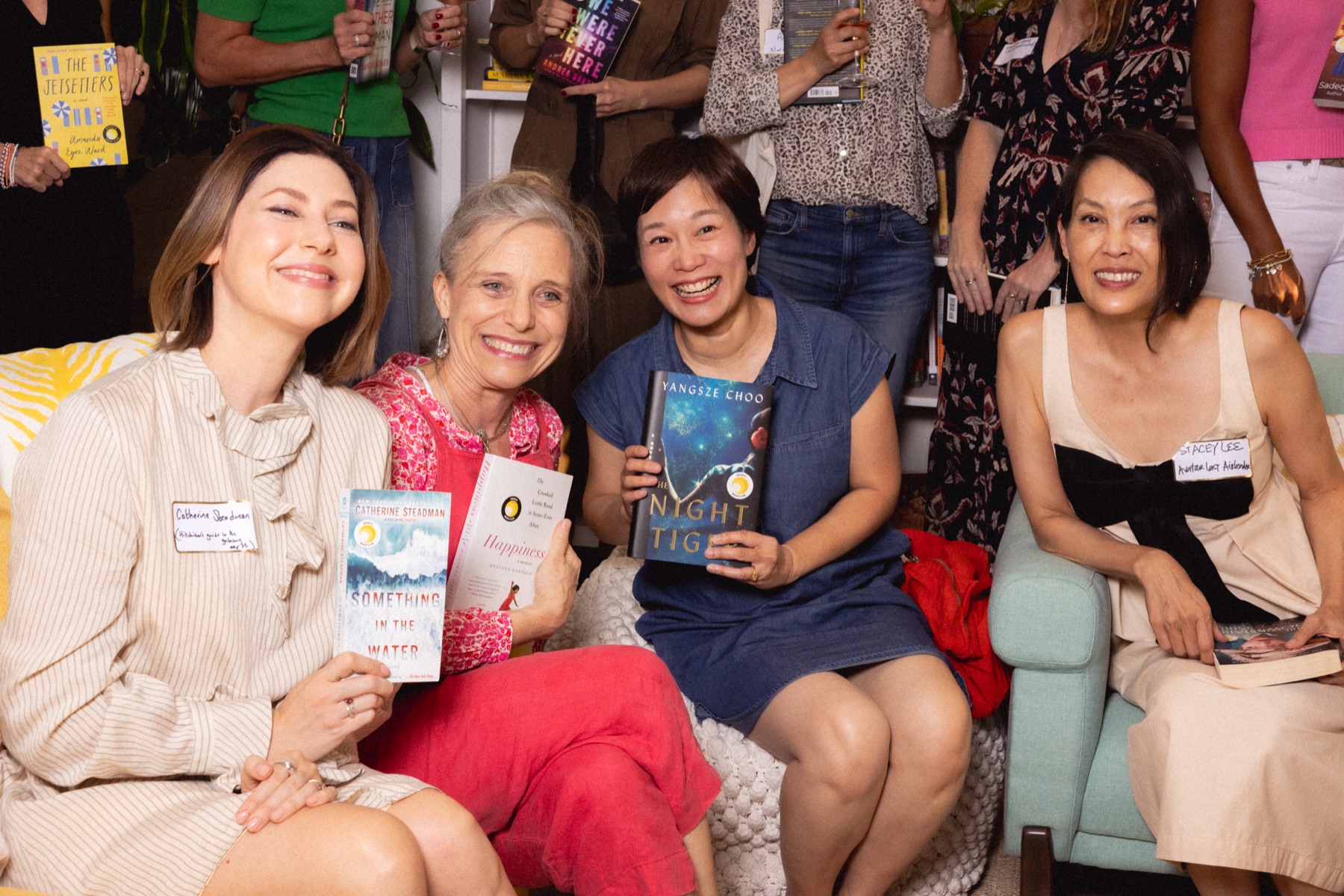 Four Reese’s Book Club authors smiling with their books