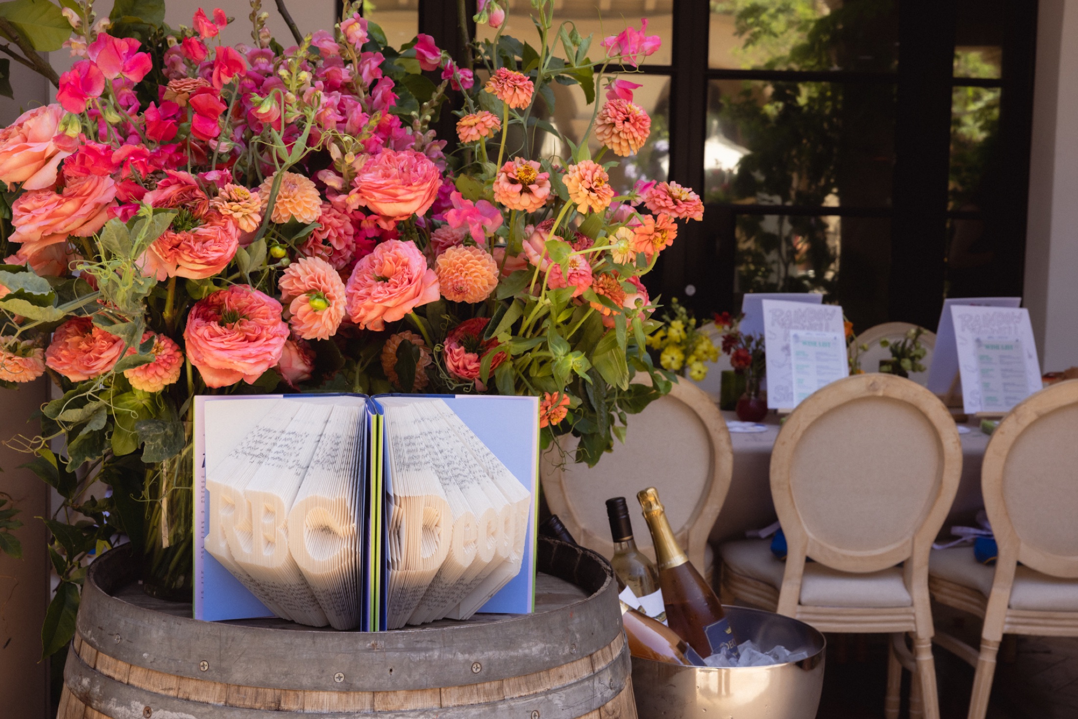Folded book art and bright flowers at Read, Sip, Repeat