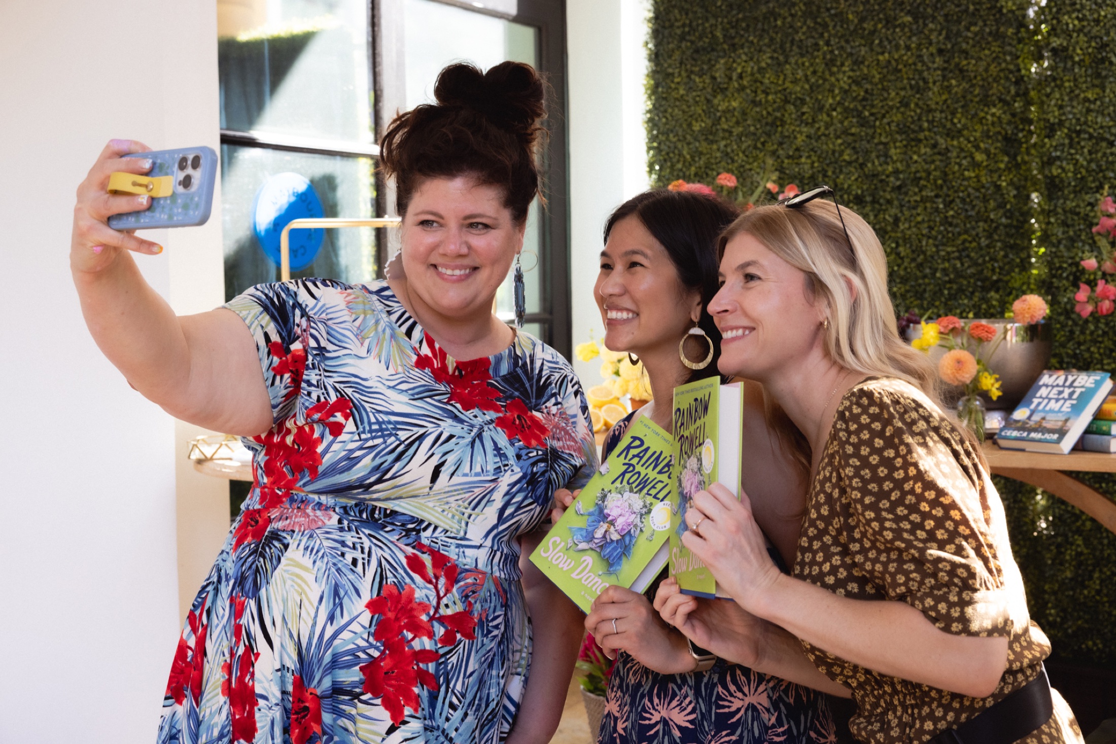 Rainbow Rowell taking a photo with guests holding copies of Slow Dance