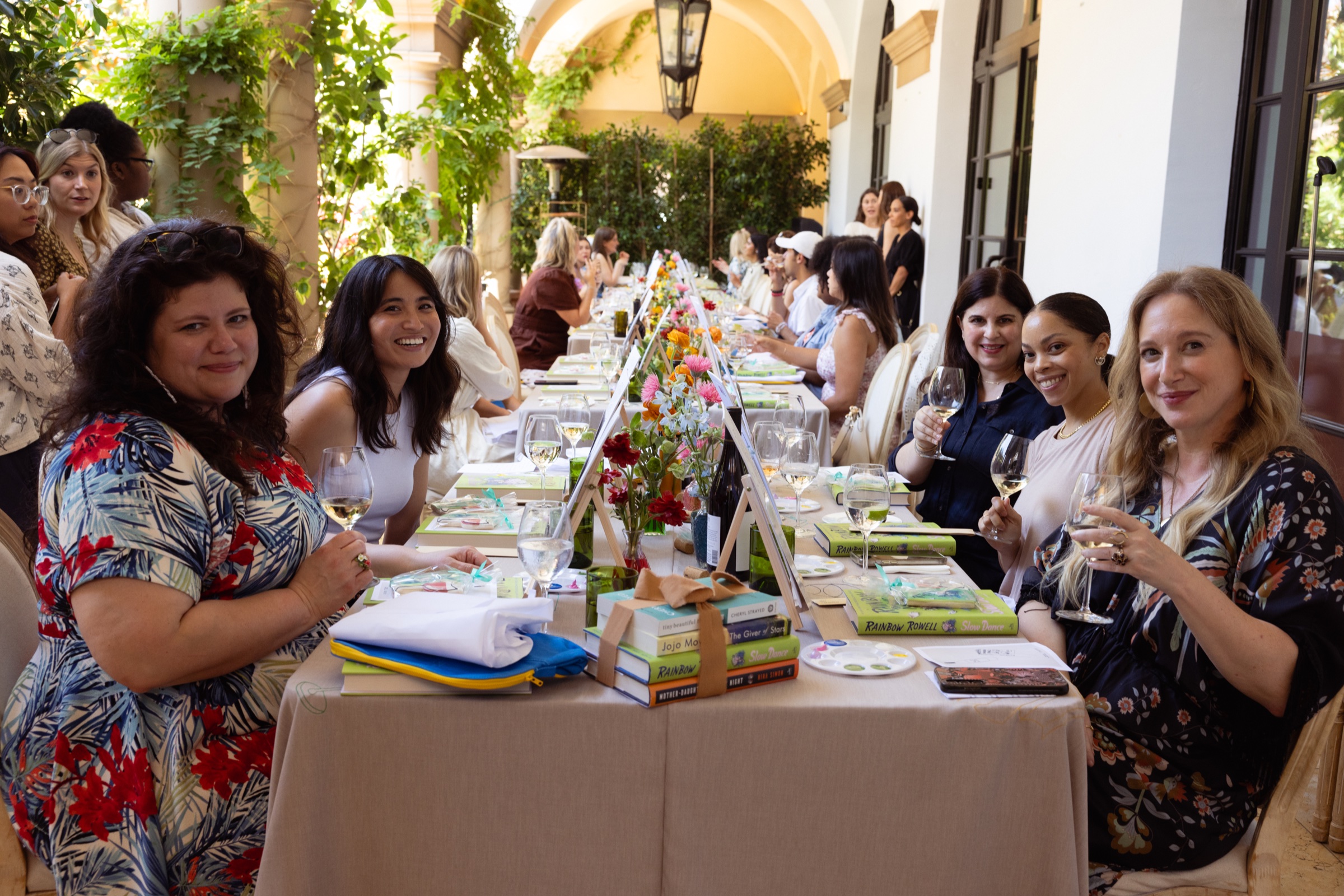 Rainbow Rowell and guests gathered around a long table for Read, Sip, Repeat