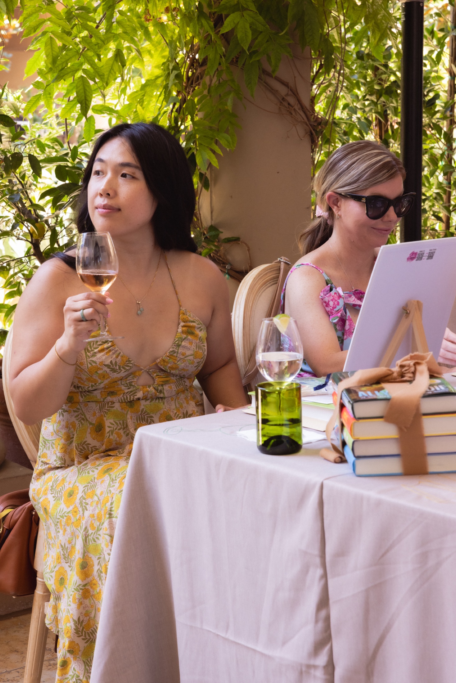 A guest enjoying wine while painting at Read, Sip, Repeat